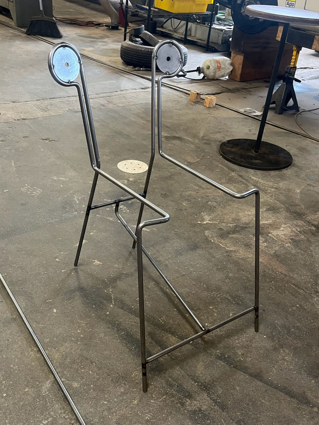 Bent steel rod chair in a workshop