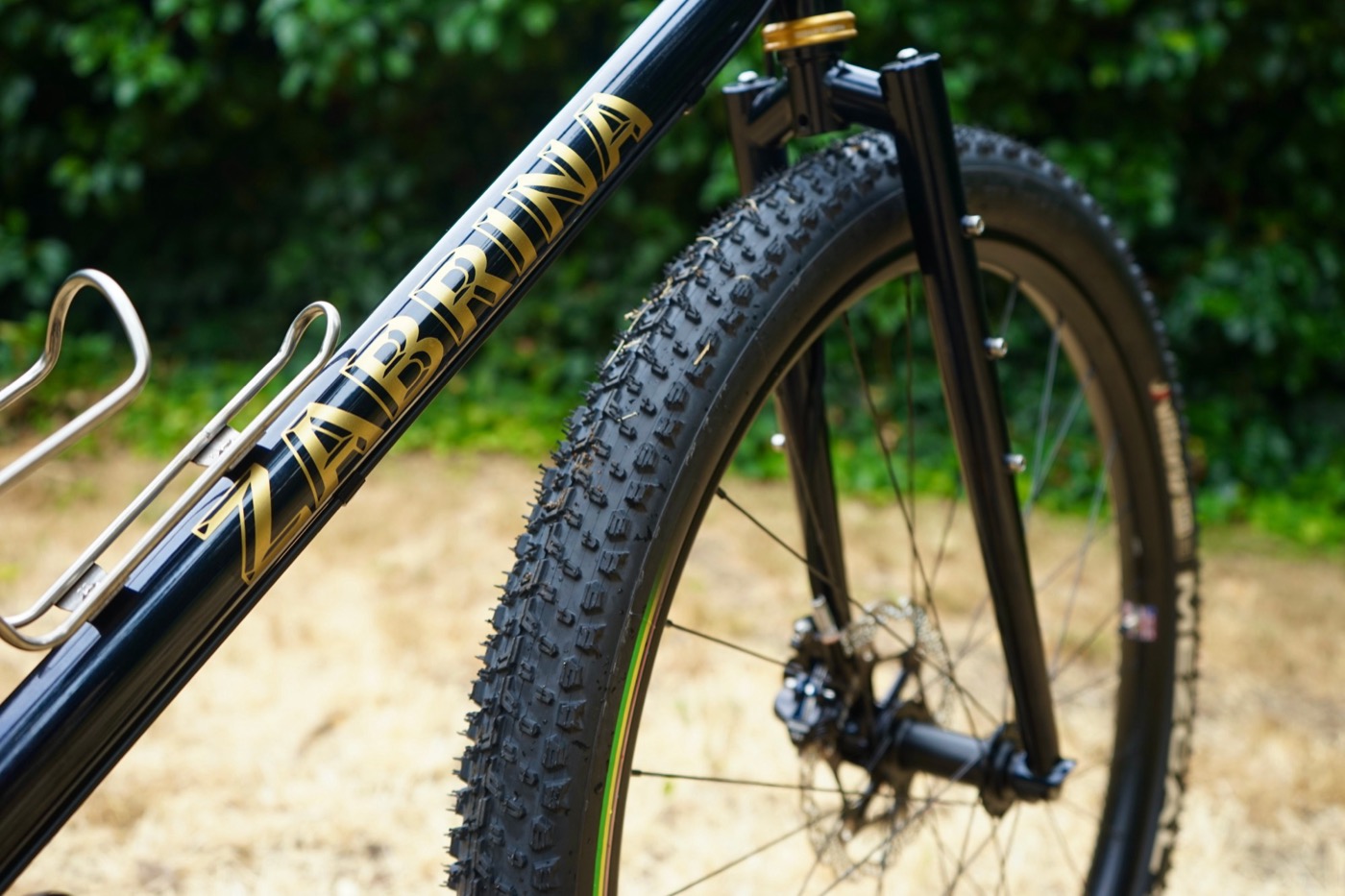 Gold Zabrina lettering on the down tube beside a knobby front tire