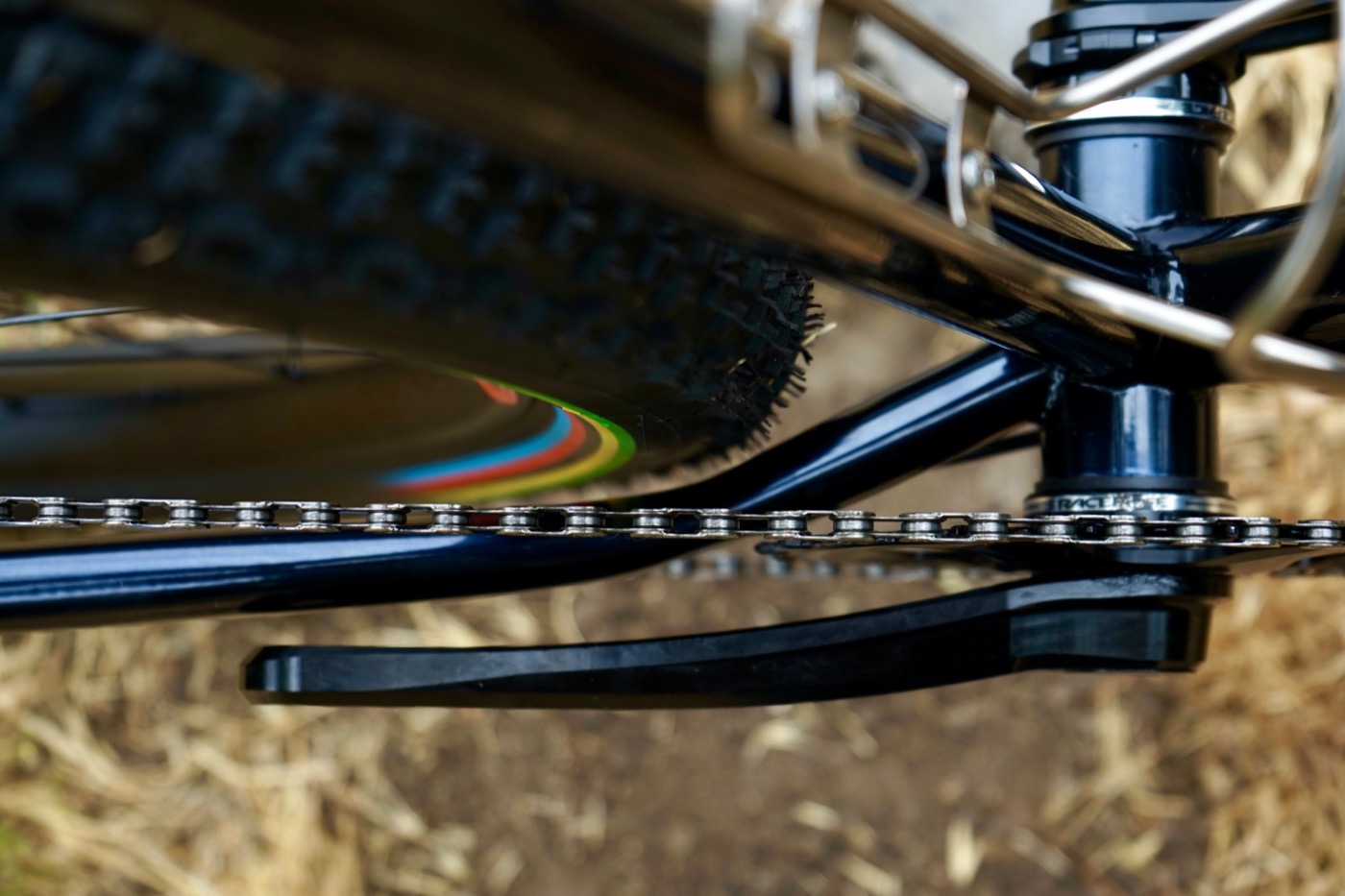 Chainstay and bottom bracket close-up with rainbow rim stripe