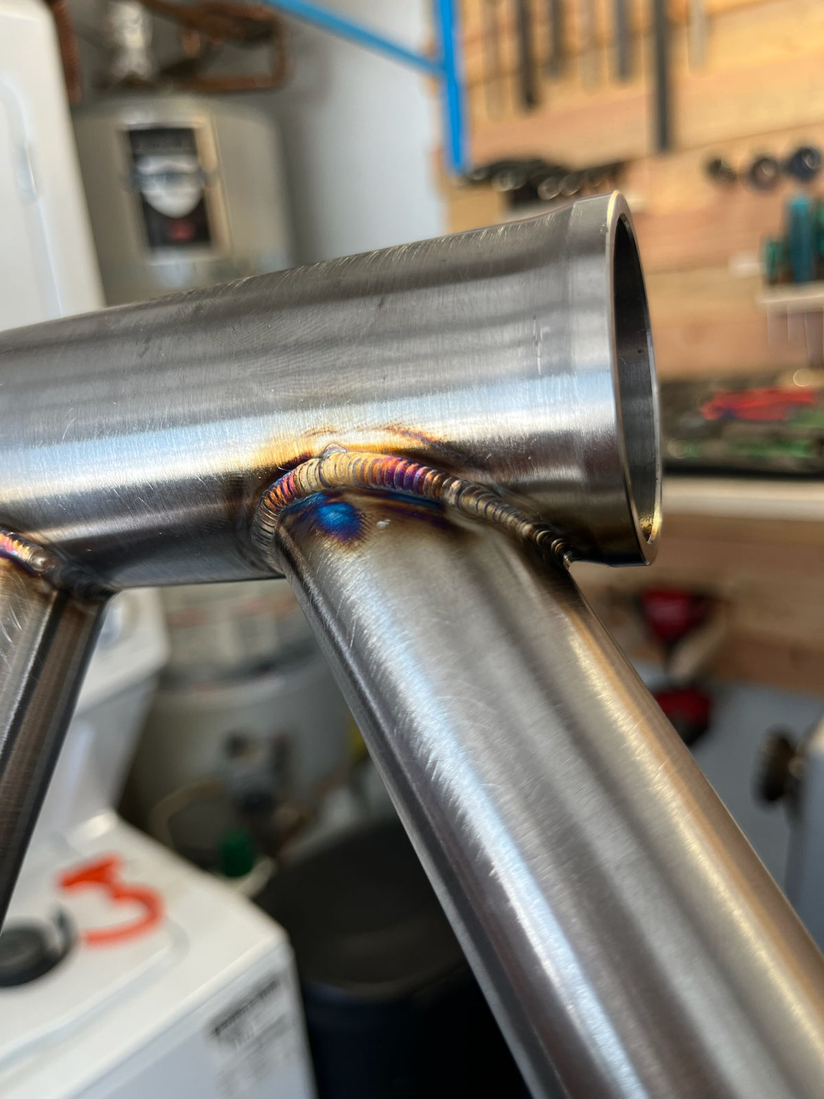 Head tube junction weld, with the garage shop in the background