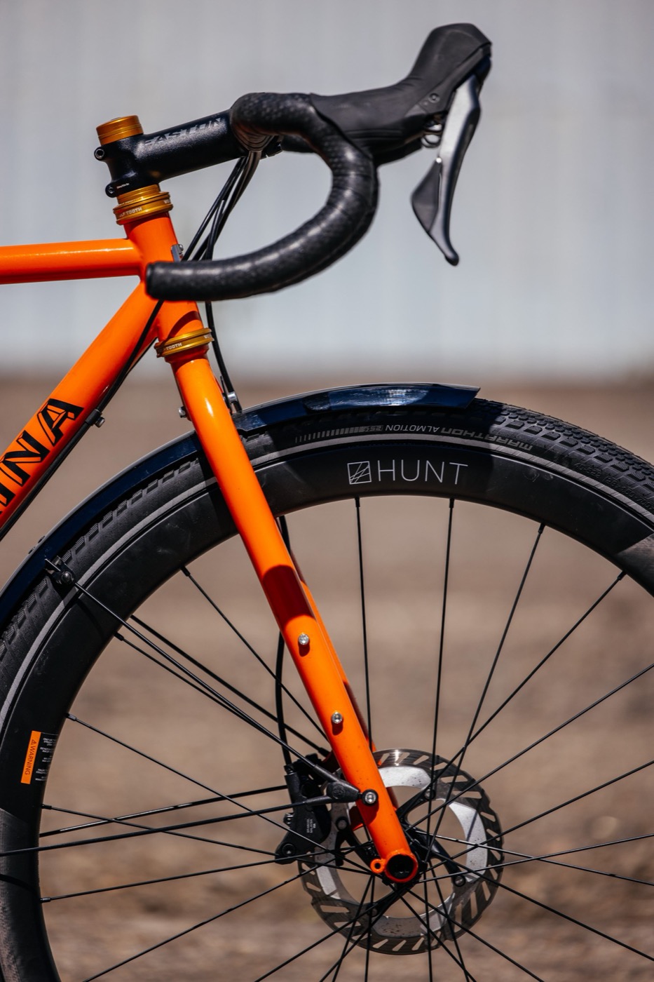 Orange fork, fender and drop bars from the side