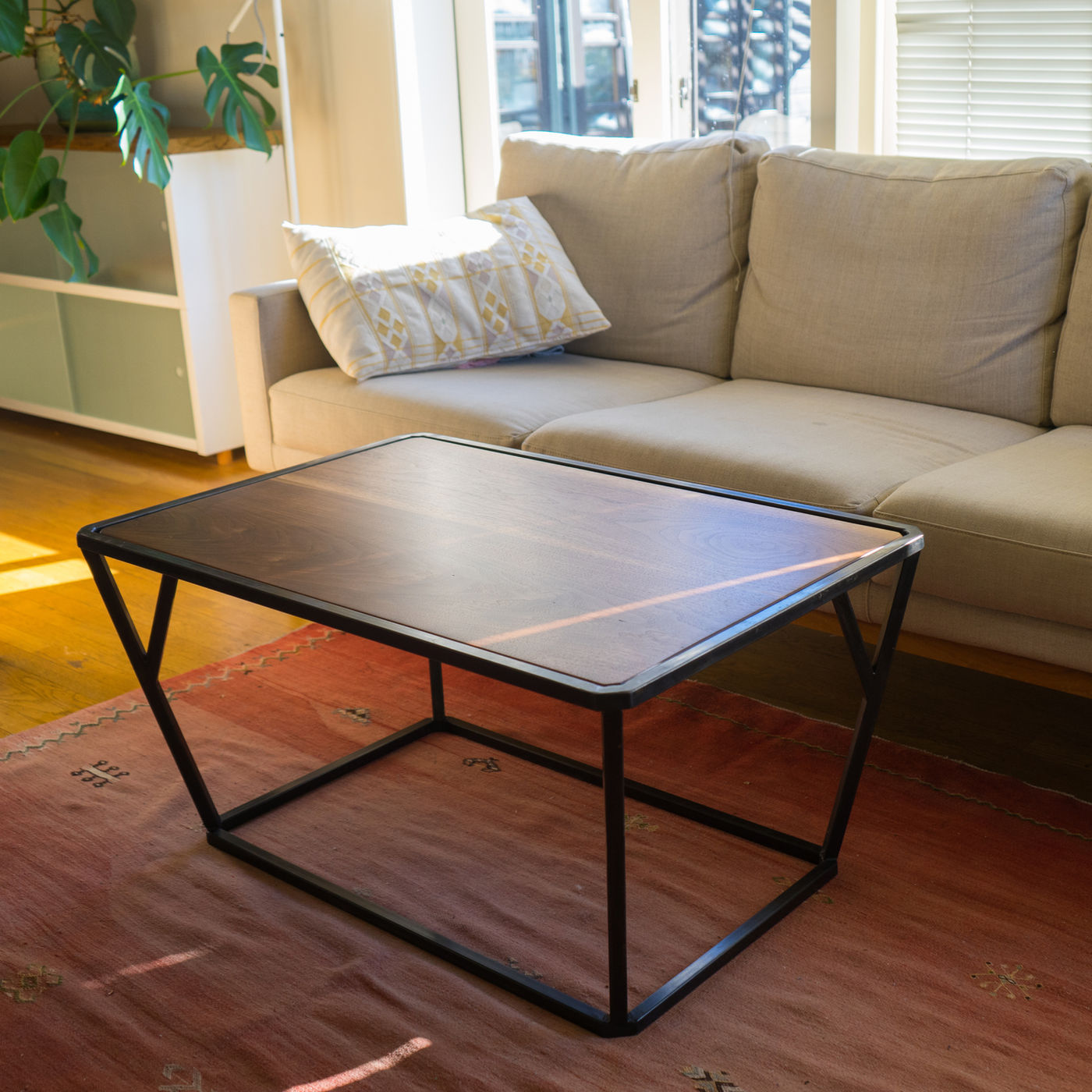 Steel-framed coffee table with a wood top in a living room